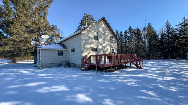 snow covered property featuring a wooden deck