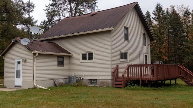 back of house featuring a wooden deck, a yard, and central air condition unit