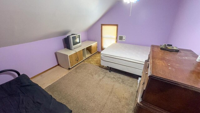 carpeted bedroom with vaulted ceiling