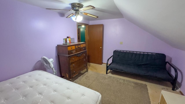 carpeted bedroom with ceiling fan and vaulted ceiling