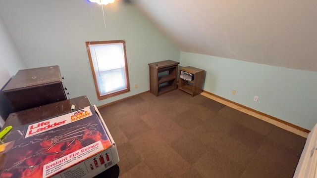 bonus room with vaulted ceiling and dark carpet