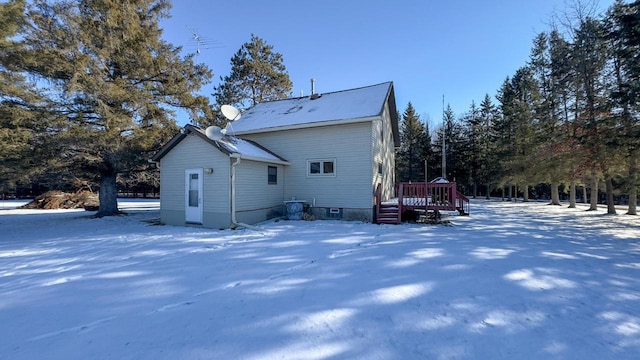 view of snowy exterior with a wooden deck