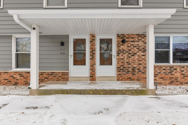 view of snow covered property entrance