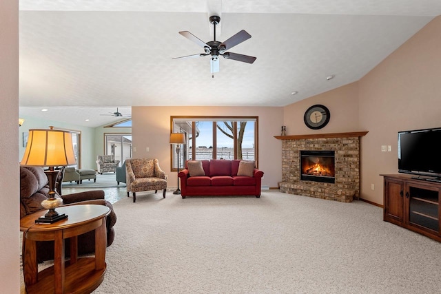 carpeted living room with ceiling fan, a brick fireplace, and lofted ceiling