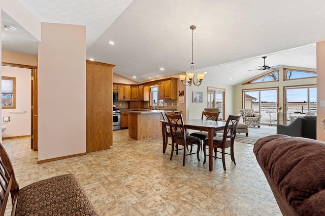 dining room with vaulted ceiling and ceiling fan with notable chandelier