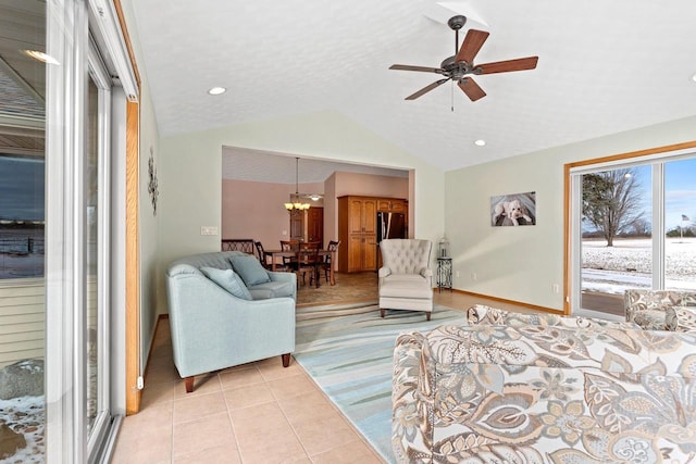 bedroom featuring light tile patterned floors, ceiling fan, access to outside, fridge, and vaulted ceiling