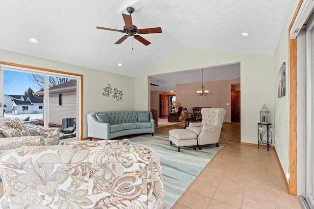 tiled living room with ceiling fan with notable chandelier and vaulted ceiling