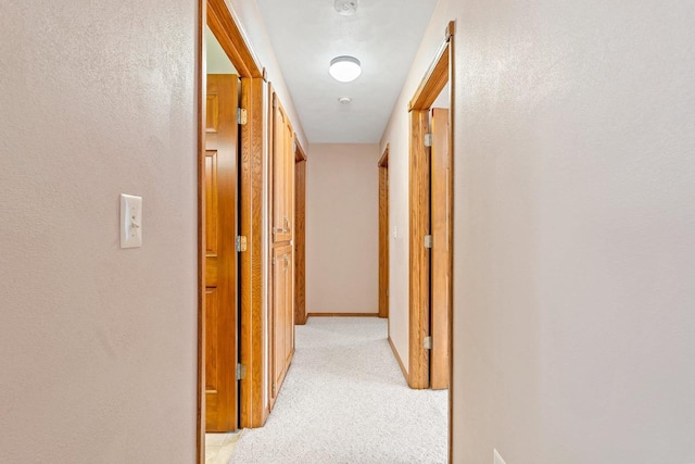 corridor with light colored carpet