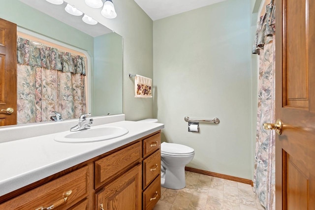 bathroom featuring toilet and vanity