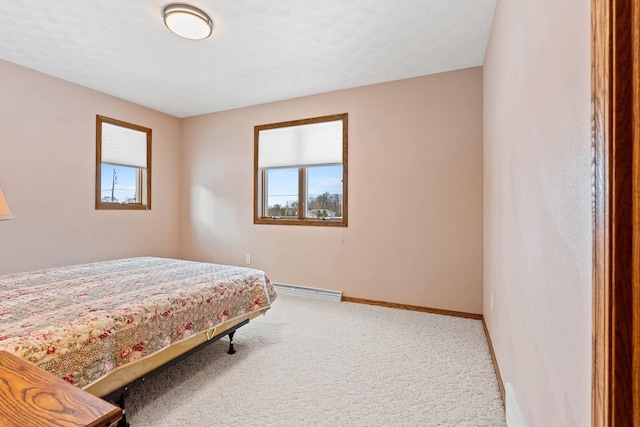 carpeted bedroom featuring baseboard heating