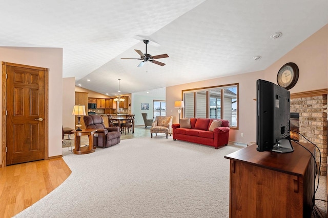 carpeted living room with ceiling fan, a textured ceiling, and lofted ceiling