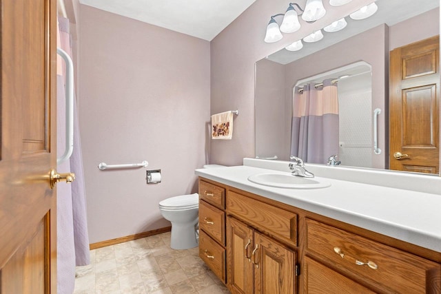 bathroom featuring toilet and vanity