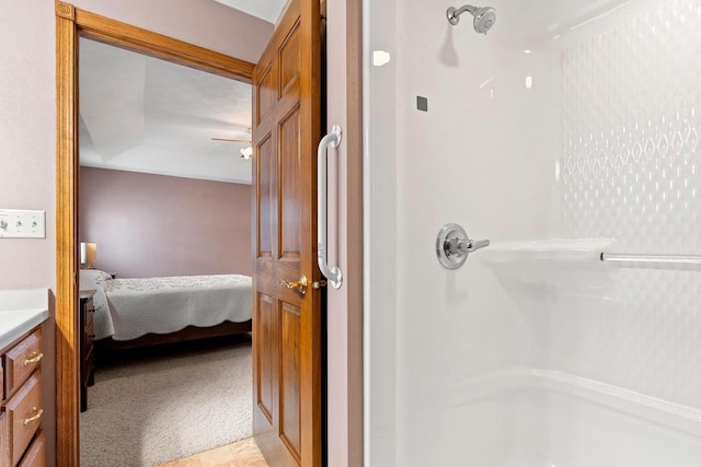 bathroom with a shower, vanity, and vaulted ceiling