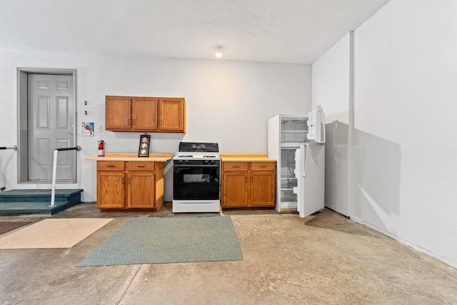 kitchen with concrete floors and gas stove