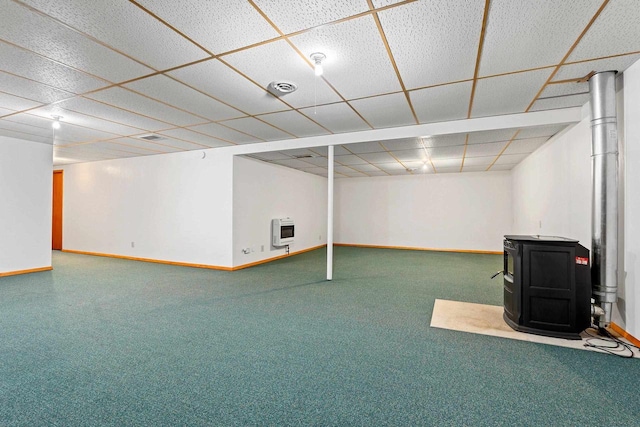 basement featuring carpet, heating unit, and a drop ceiling