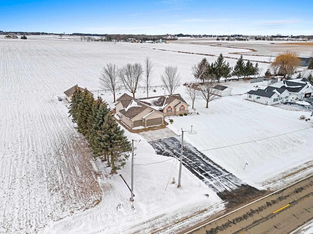 snowy aerial view featuring a rural view