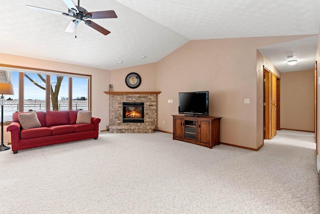 living room with lofted ceiling, light colored carpet, ceiling fan, and a fireplace