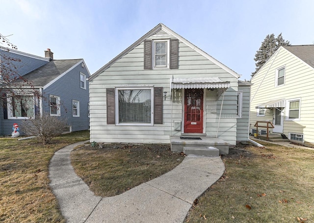 bungalow-style home with a front yard