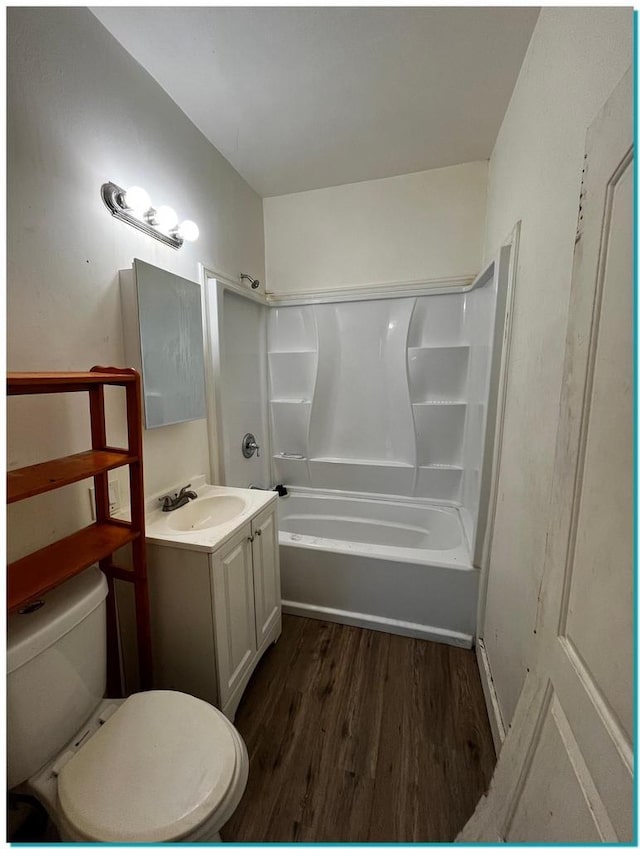 full bathroom featuring toilet, bathtub / shower combination, vanity, and hardwood / wood-style floors