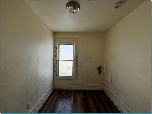 empty room with dark wood-type flooring