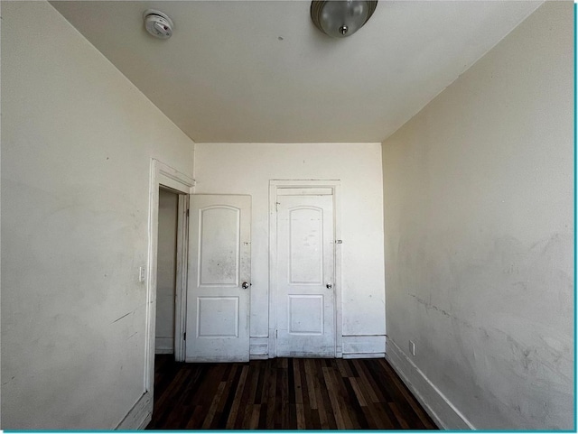 corridor featuring dark hardwood / wood-style flooring