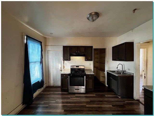 kitchen featuring dark hardwood / wood-style flooring, sink, dark brown cabinets, and stainless steel gas range oven