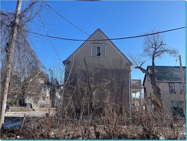 view of side of property with a balcony