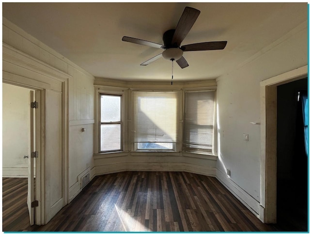 spare room featuring ceiling fan and dark hardwood / wood-style flooring