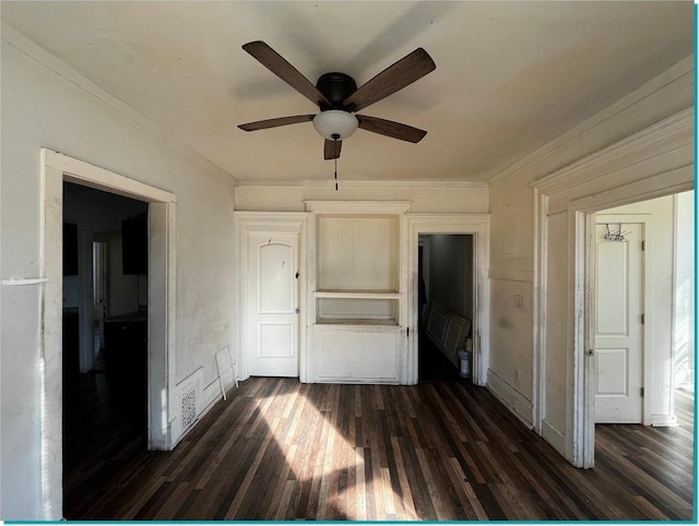 unfurnished bedroom featuring ceiling fan, dark wood-type flooring, and crown molding