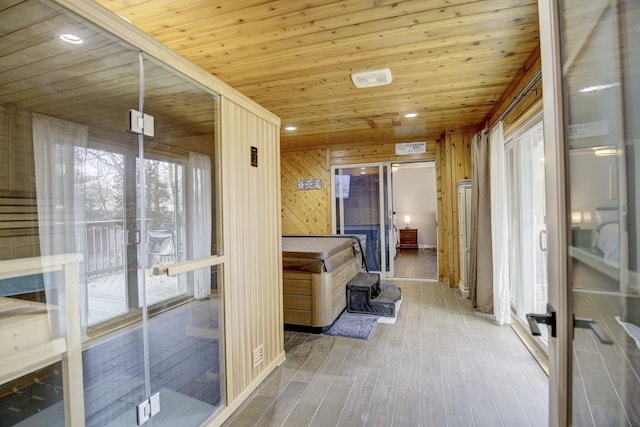 interior space featuring wood ceiling, wood walls, and hardwood / wood-style floors