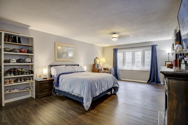 bedroom with dark wood-type flooring and ceiling fan