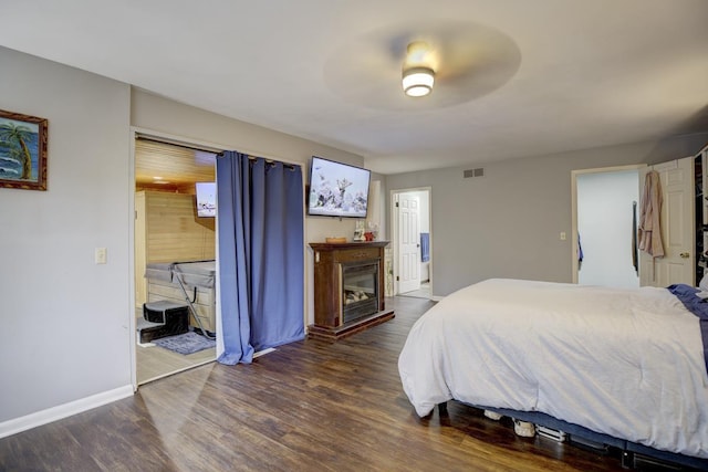 bedroom with ceiling fan and dark hardwood / wood-style flooring