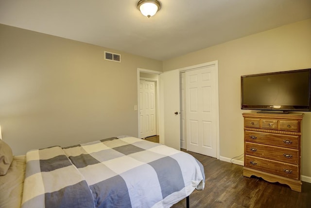 bedroom with a closet and dark hardwood / wood-style flooring