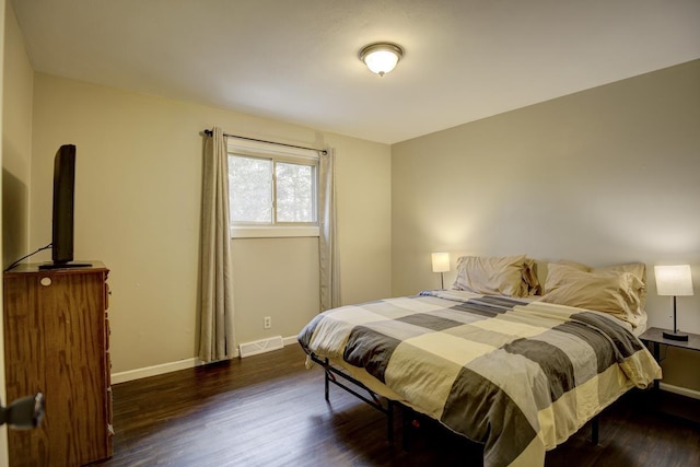 bedroom featuring dark hardwood / wood-style flooring