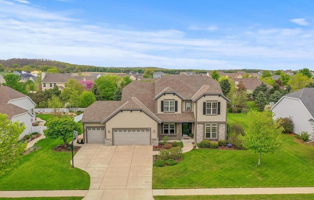 view of front of home with a garage and a front yard