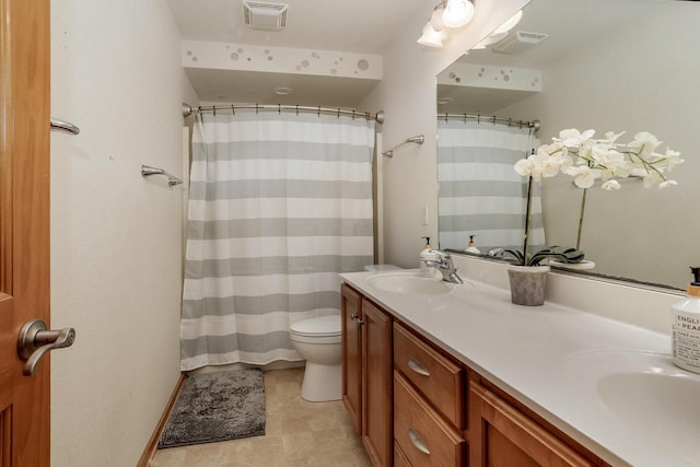 bathroom featuring toilet and vanity