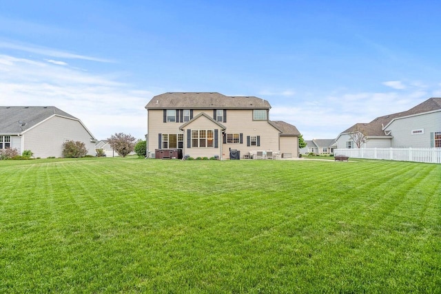 rear view of house featuring a yard