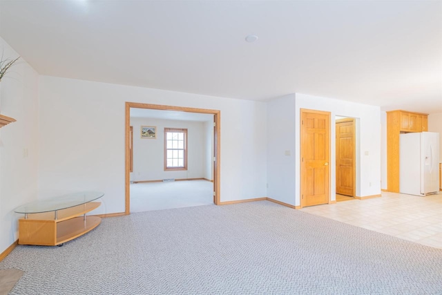 unfurnished room with light colored carpet