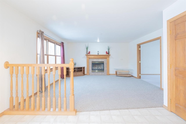 unfurnished living room with light carpet and a fireplace