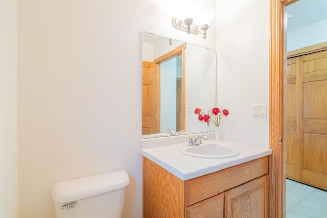 bathroom with toilet and vanity