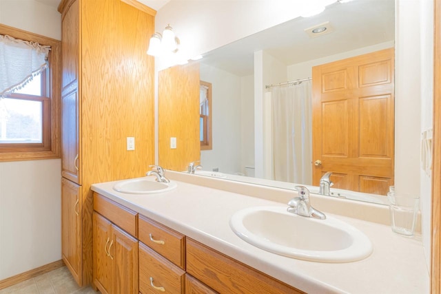 bathroom with toilet and vanity