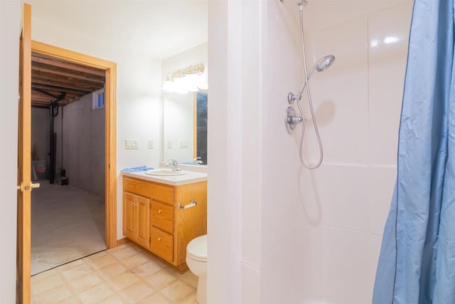 bathroom featuring toilet, vanity, and curtained shower