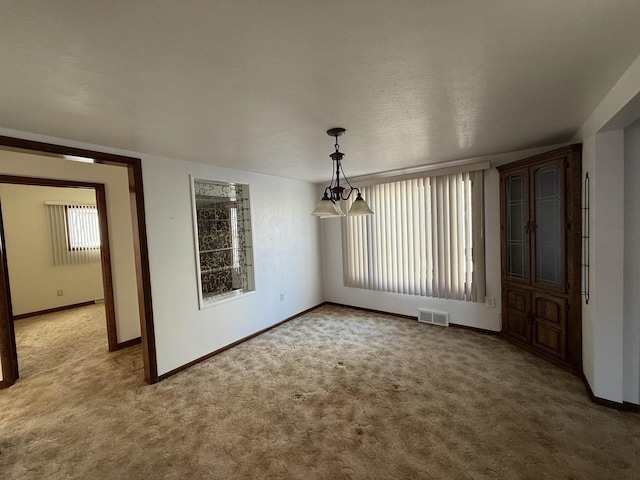 unfurnished dining area featuring carpet and plenty of natural light