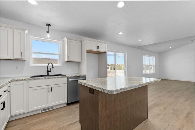 kitchen featuring light hardwood / wood-style floors, dishwasher, hanging light fixtures, white cabinets, and sink