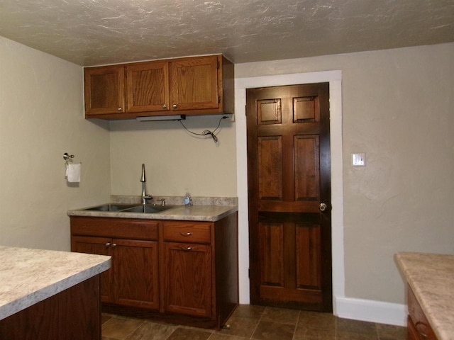 kitchen with sink and a textured ceiling