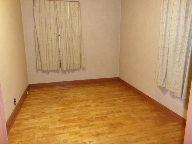 spare room featuring light wood-type flooring