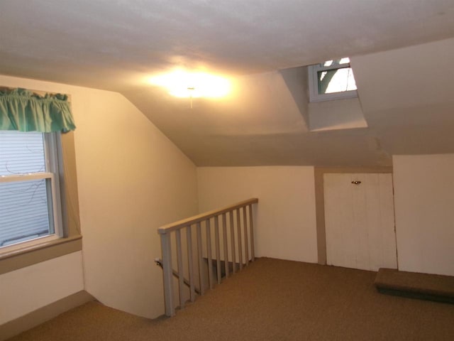 bonus room featuring lofted ceiling and carpet flooring