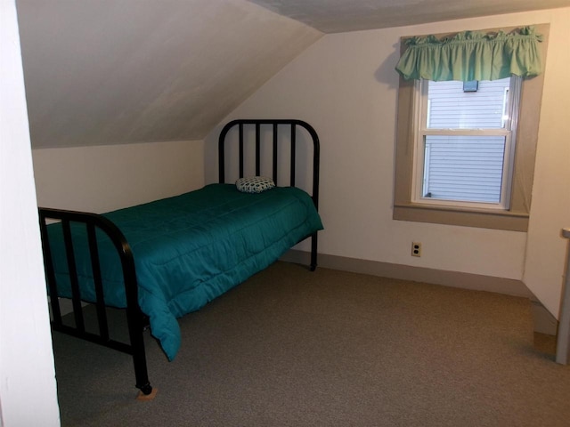 bedroom featuring carpet and lofted ceiling