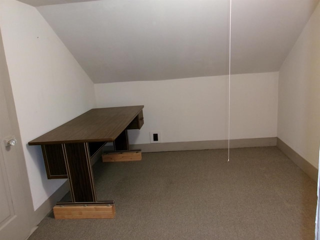additional living space with carpet flooring and lofted ceiling