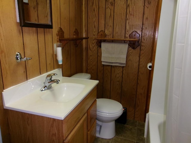 bathroom with toilet, a tub, tile patterned floors, and vanity